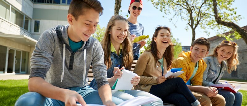 group of students with notebooks at school yard
