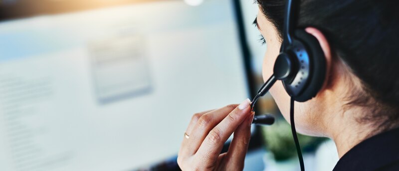Managing the days inquiries. Rearview shot of a young woman working in a call centre.