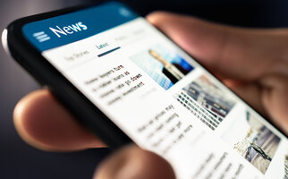 News online. Phone with newspaper headlines and feed. Digital press article. Reader watching latest titles. Mockup media publication website in smartphone. Man reading text on mobile screen. 