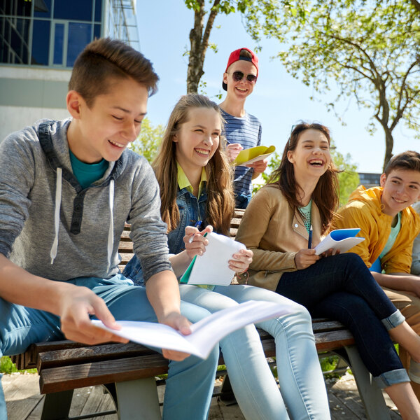 group of students with notebooks at school yard