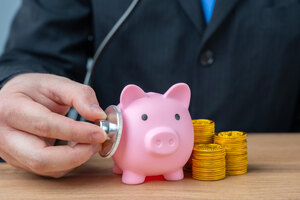 The businessman listens to the pig piglet with a stethoscope. Financial health. Liquidity of assets. Economic security. Accounting management.