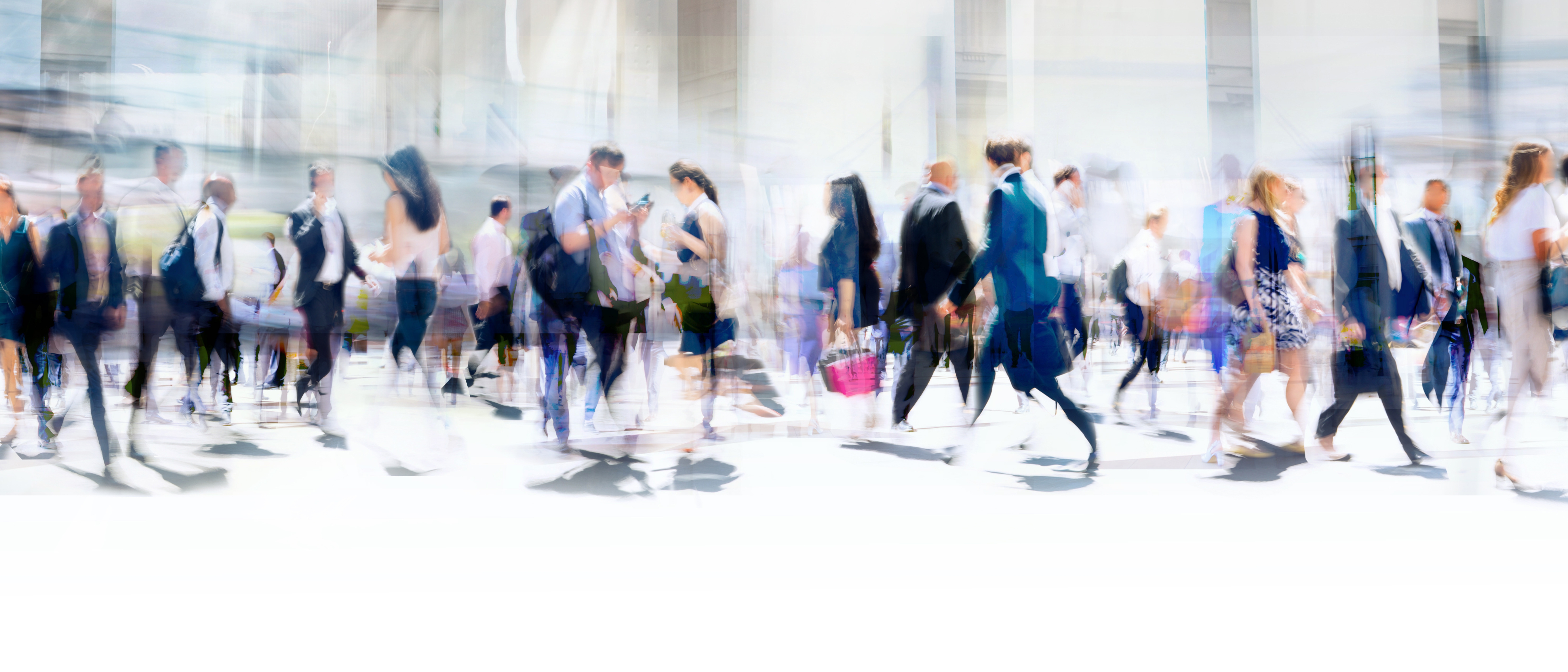 Walking people blur. Lots of people walking in the City of London. Wide panoramic view of people crossing the road.