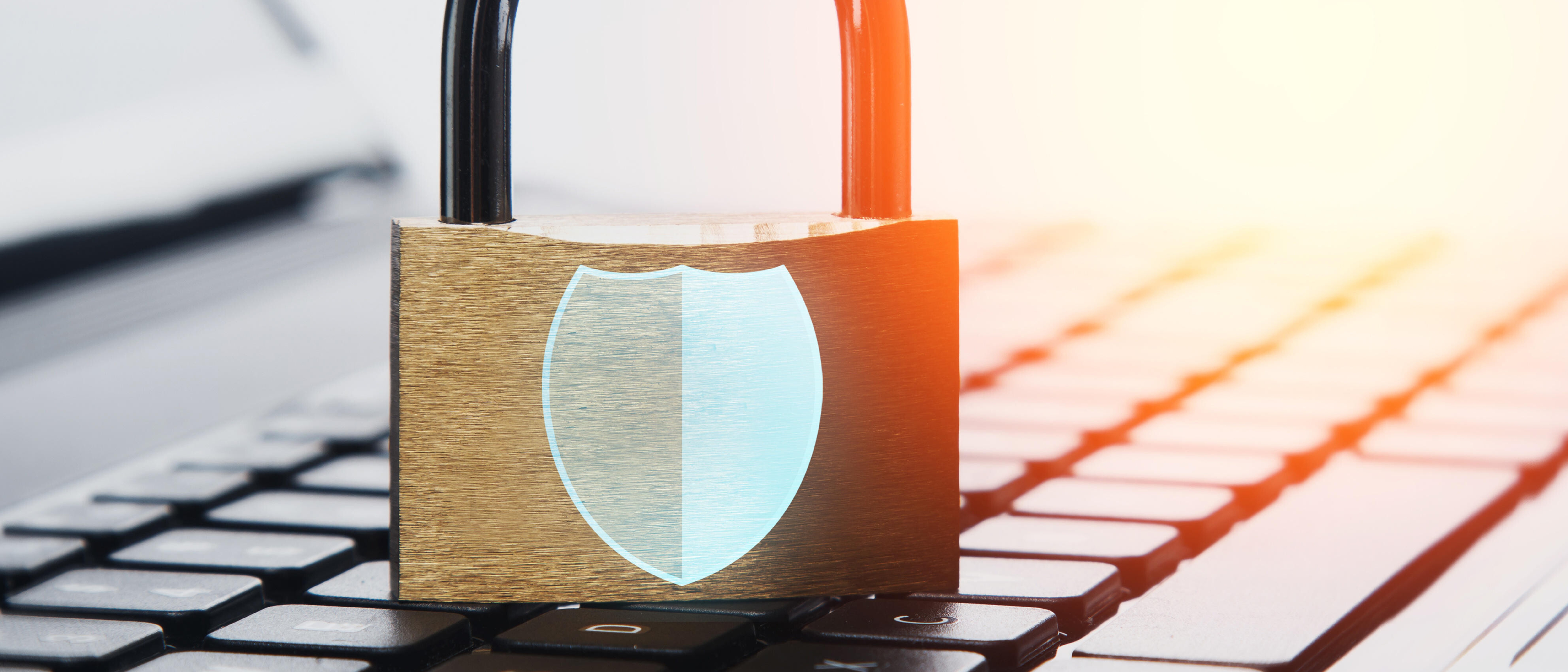 Padlock and laptop computer with Shield symbol. Concepts of information privacy and cyber security.