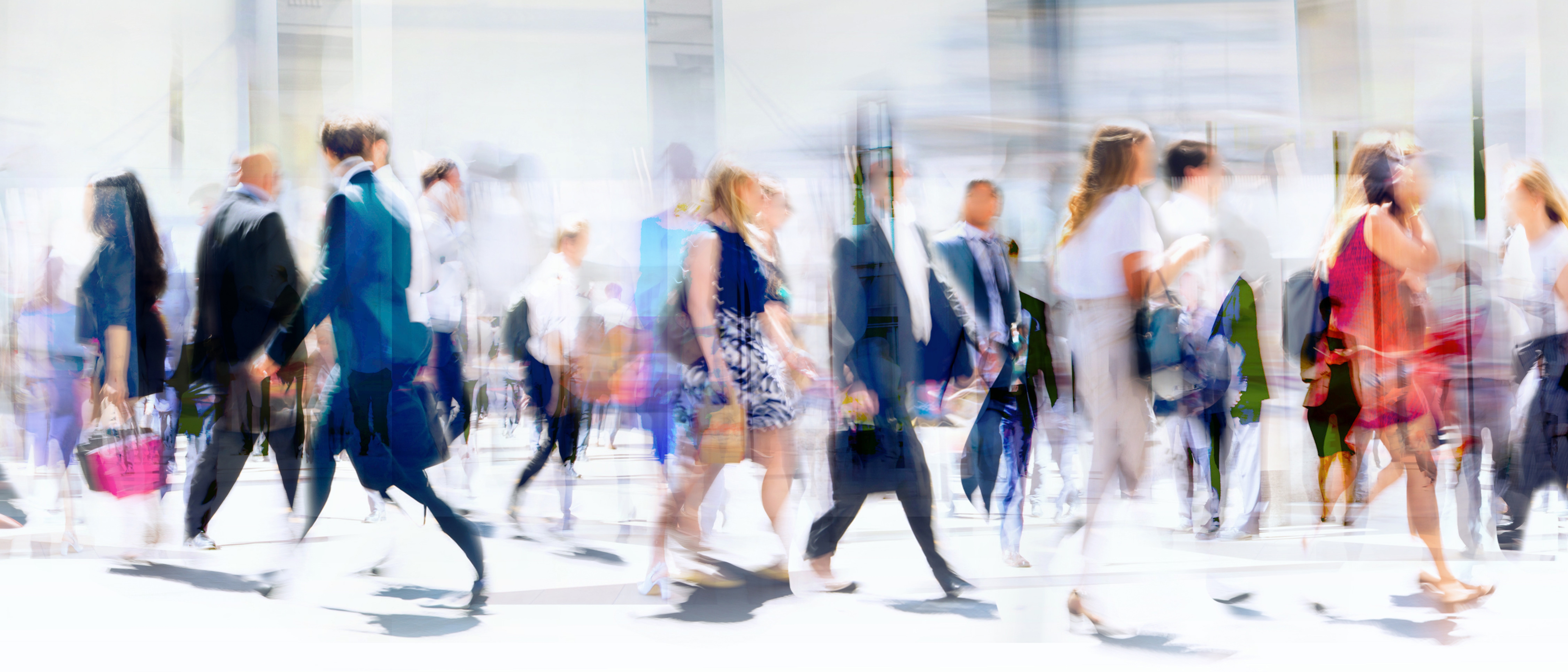 Walking people blur. Lots of people walking in the City of London. Wide panoramic view of people crossing the road.